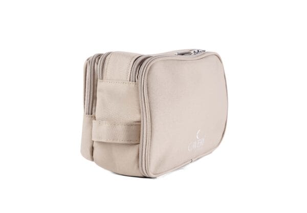Neutral-toned sand toiletry bag by Caveri, featuring minimalist aesthetic and spacious compartments