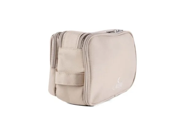 Neutral-toned sand toiletry bag by Caveri, featuring minimalist aesthetic and spacious compartments