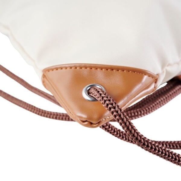 Up close contrast details of caveri's Eco-friendly drawstring day bag with adjustable straps, durable recycled fabric, and spacious compartments for gym essentials or travel gear