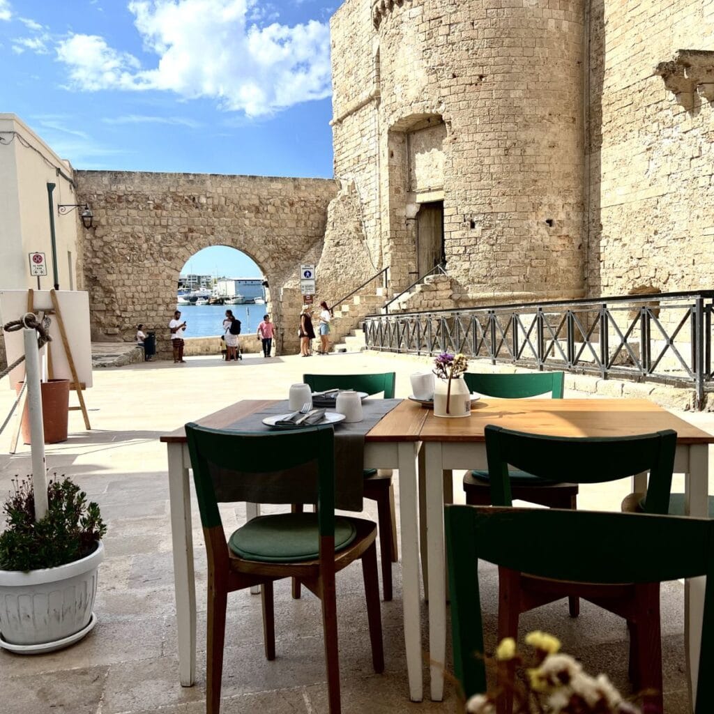 A stunning restaurant overlooking the sparkling harbor in Bari, Italy, with breathtaking views of the Adriatic Sea and vibrant coastal charm