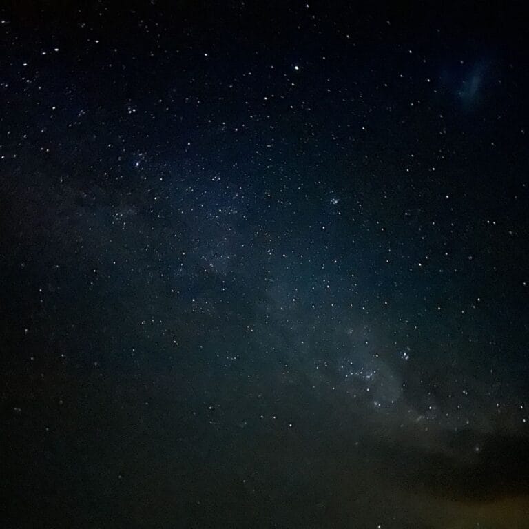 A star-filled night sky over the Lancelin Dunes near the Pinnacles Desert, with the Milky Way visible above the sandy landscape