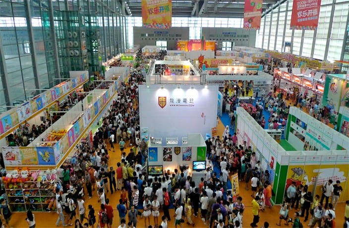 Crowded exhibition hall at the Canton Fair, filled with enthusiastic attendees interacting with exhibitors at colorful product booths.