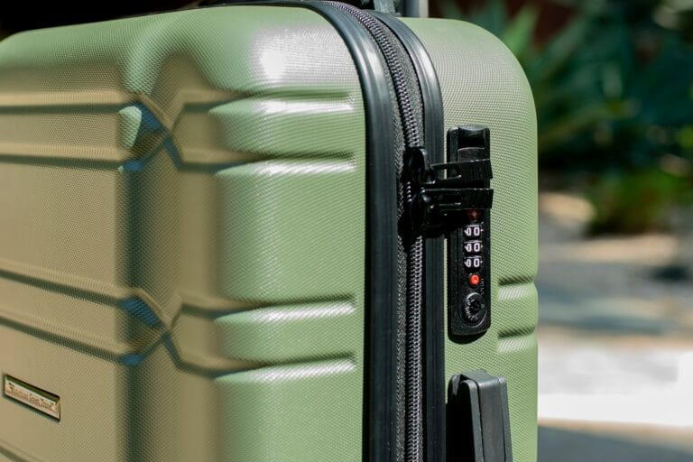 A close-up of a suitcase with a TSA-approved combination lock, showing the red Travel Sentry logo