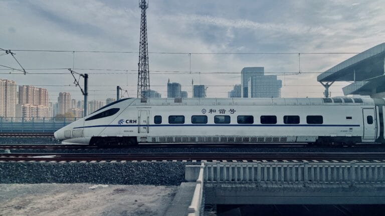 China high-speed rail train at station platform, modern bullet train with sleek aerodynamic design, ready for departure