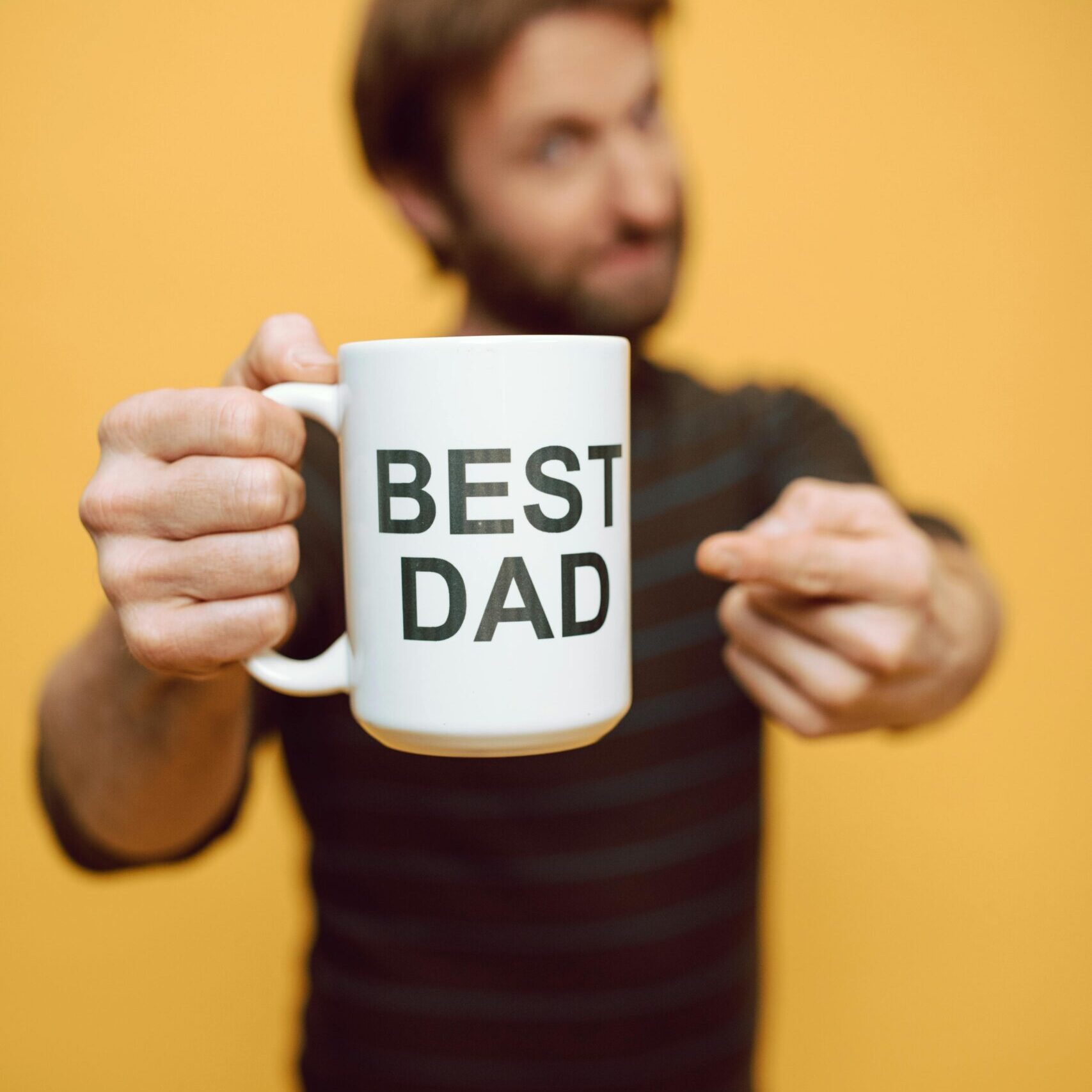 A plain white coffee mug with “Best Dad” printed on it, representing a common, predictable and boring Father’s Day gift.